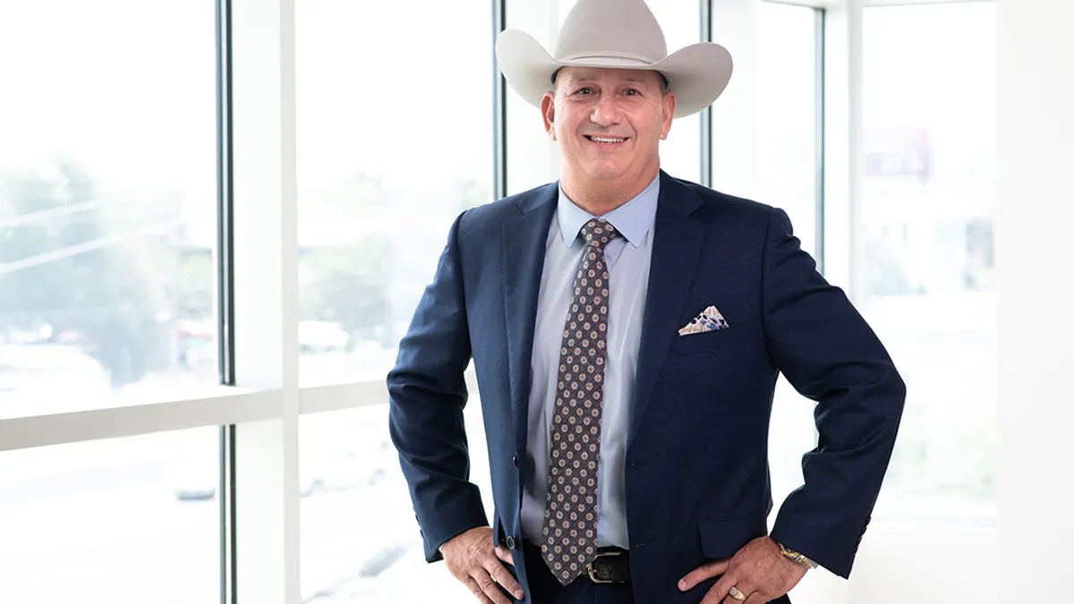 A construction executive poses in a cowboy hat.