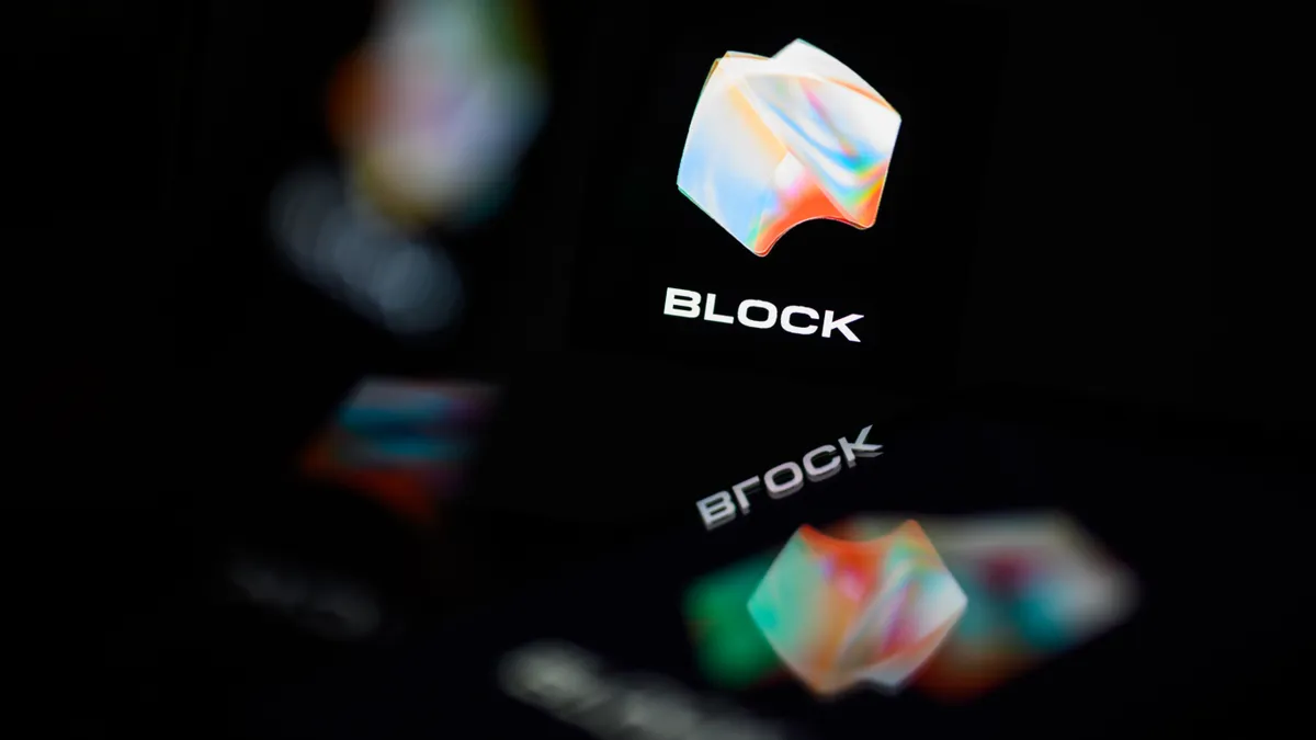 The logo for the tech firm "Block" is displayed and reflected in a number of digital screens