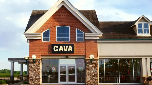 A photo of a Cava location in a brick endcap retail space.