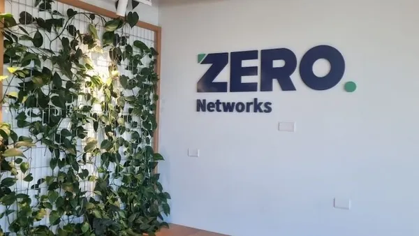 An office building lobby with the the company name Zero Networks pictured on the wall.