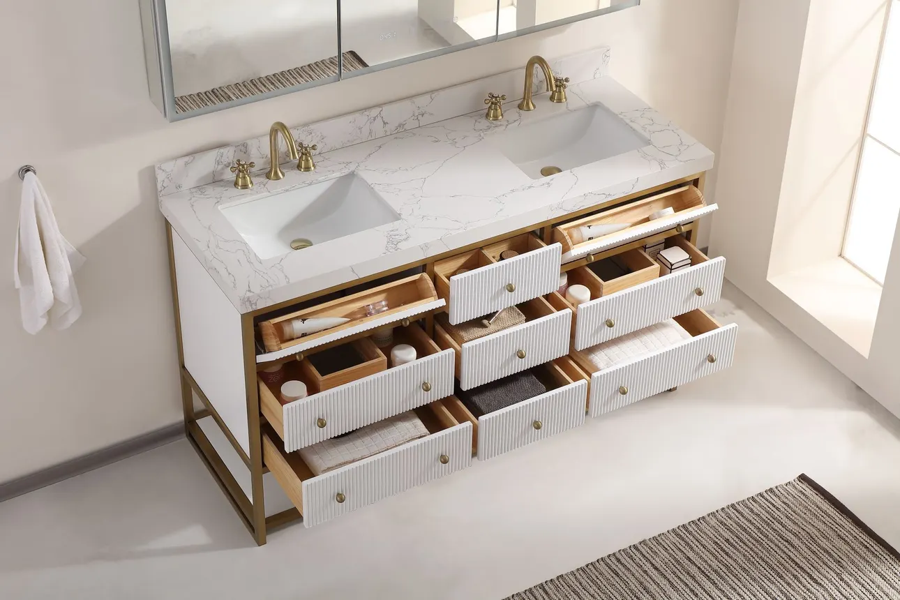 A bathroom with a white vanity with a gold frame.