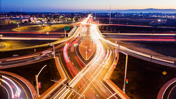 Lights from traffic blur together in this aerial photograph showing a double-diamond interchange in Manteca, California, at night.