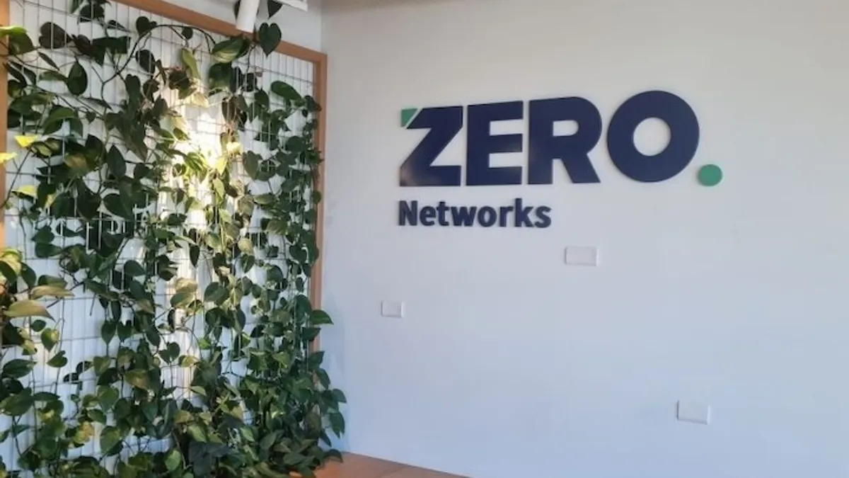 An office building lobby with the the company name Zero Networks pictured on the wall.