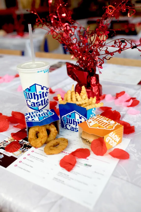 A White Castle slider combo with fries and a drink on a table decorated for Valentine&#x27;s Day.