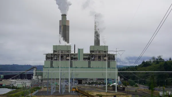 A power plant under a cloudy sky.
