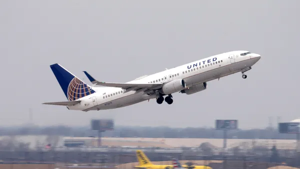 A United Airlines aircraft lifts off the tarmac.