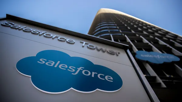 corporate signage bearing the Salesforce logo in front of a towering skyscraper