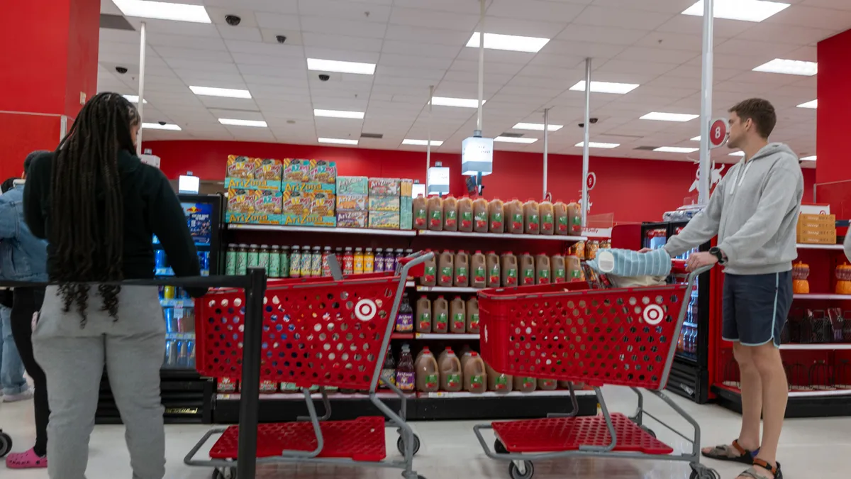 People wait in line at a Target store checkout