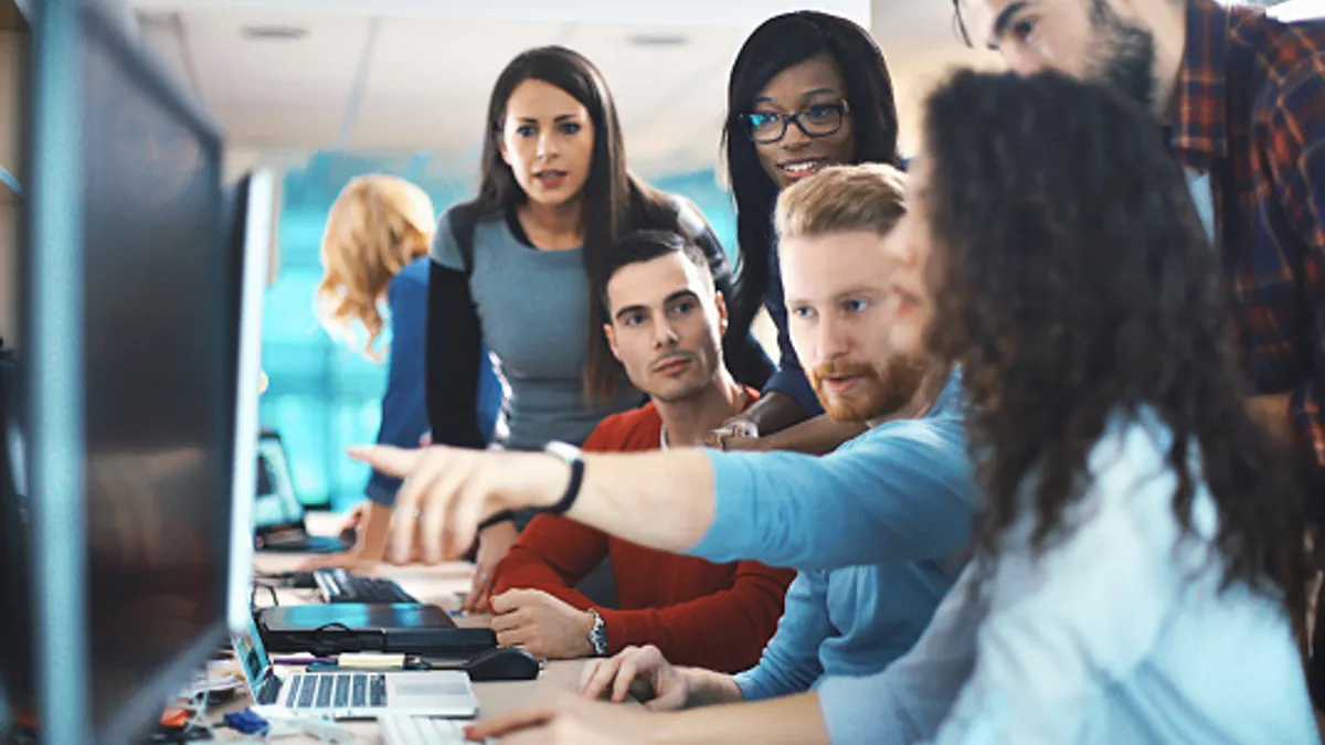 Closeup of a group learning how to implement a new tech tool