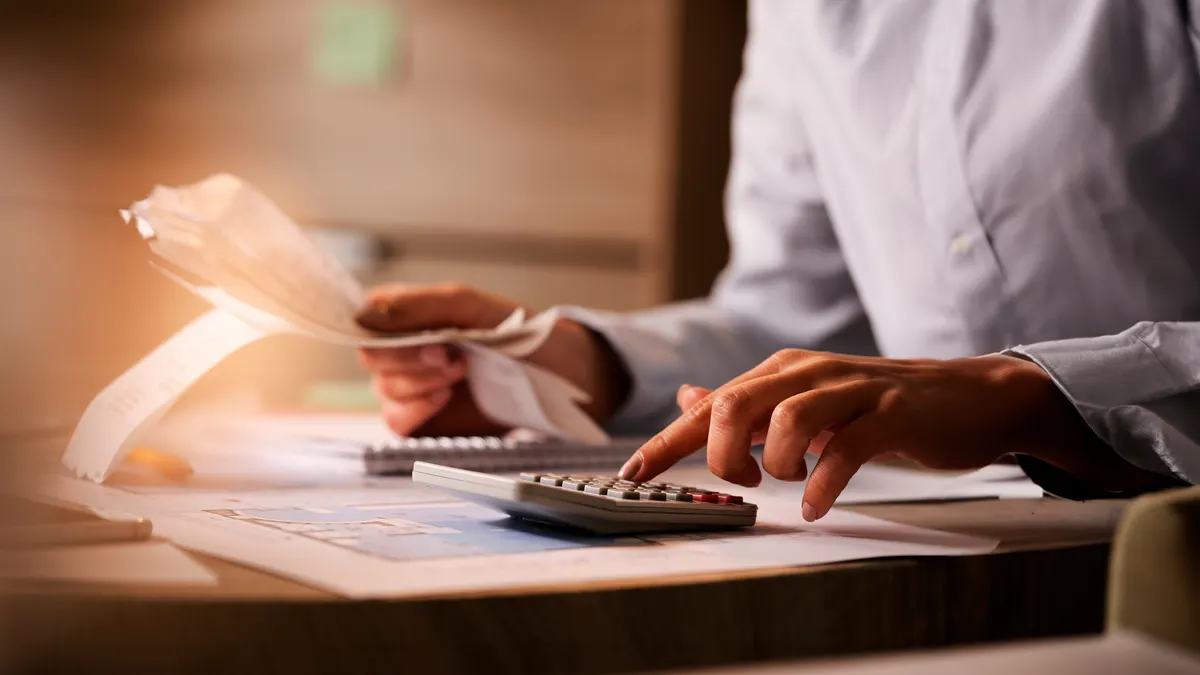 Finance financial economist using calculator accounts payable
