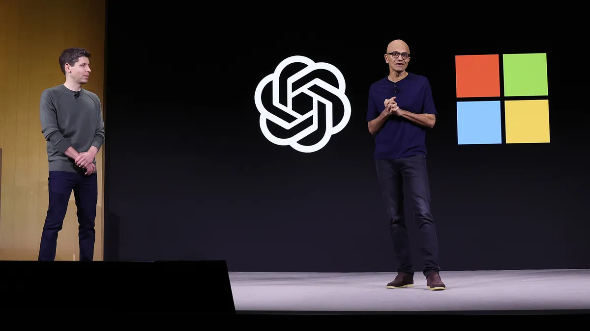 Microsoft CEO Satya Nadella speaks as OpenAI CEO Sam Altman looks on during the OpenAI DevDay event on November 06, 2023 in San Francisco, California.