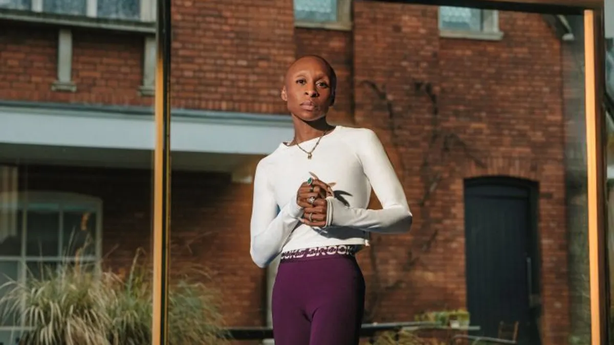 Actor Cynthia Erivo, wearing Brooks Running workout gear, looks directly into the camera in an outdoor photo shoot