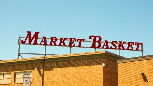 A sign above a Market Basket supermarket locatioin
