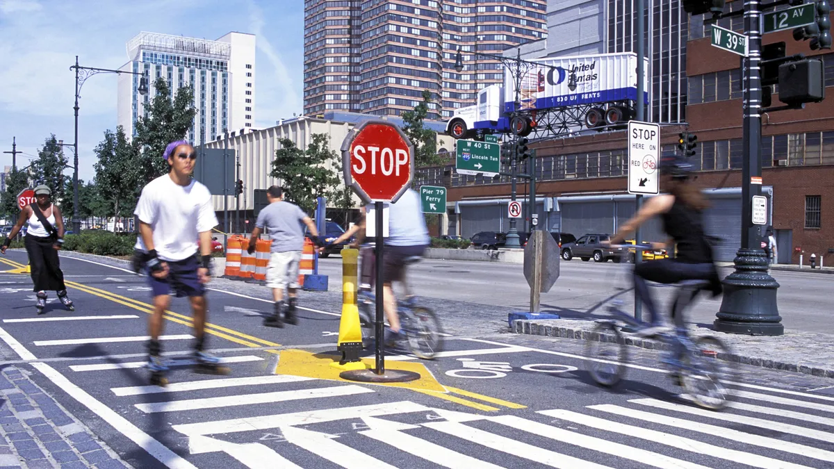 People on bicycles and skates along a bike land in Manhattan.