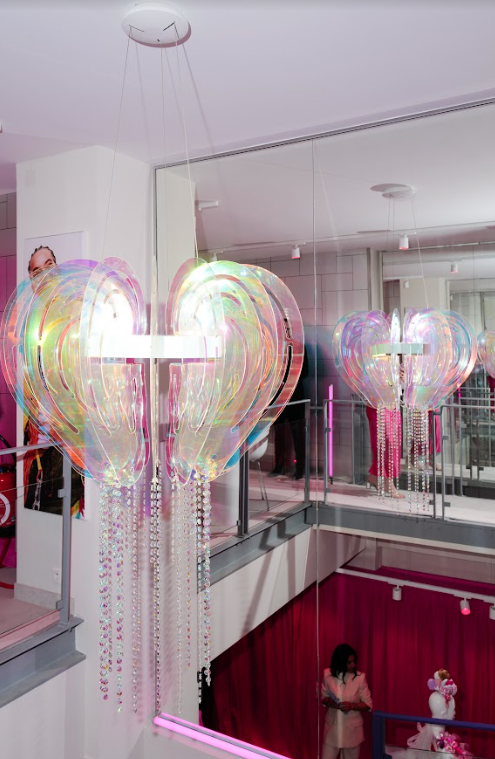 A chandelier in the shape of an ear hangs from the ceiling.