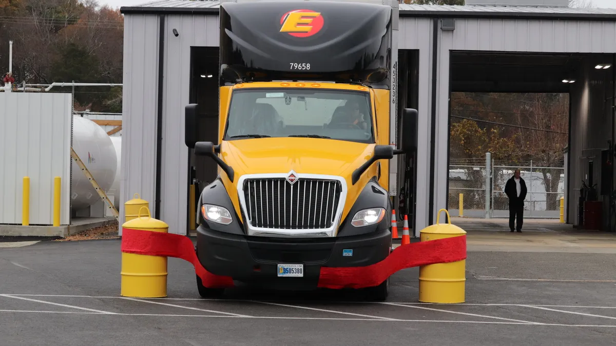 An Estes Express Lines truck drives through a ribbon at the opening of the carrier's 98-door terminal in Richmond, Virginia.