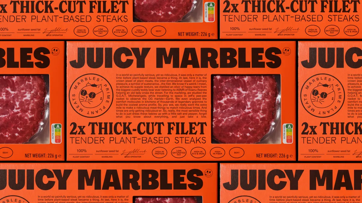 Several orange boxes of Juicy Marbles' Plant-Based Thick Cut Fillet tiled.