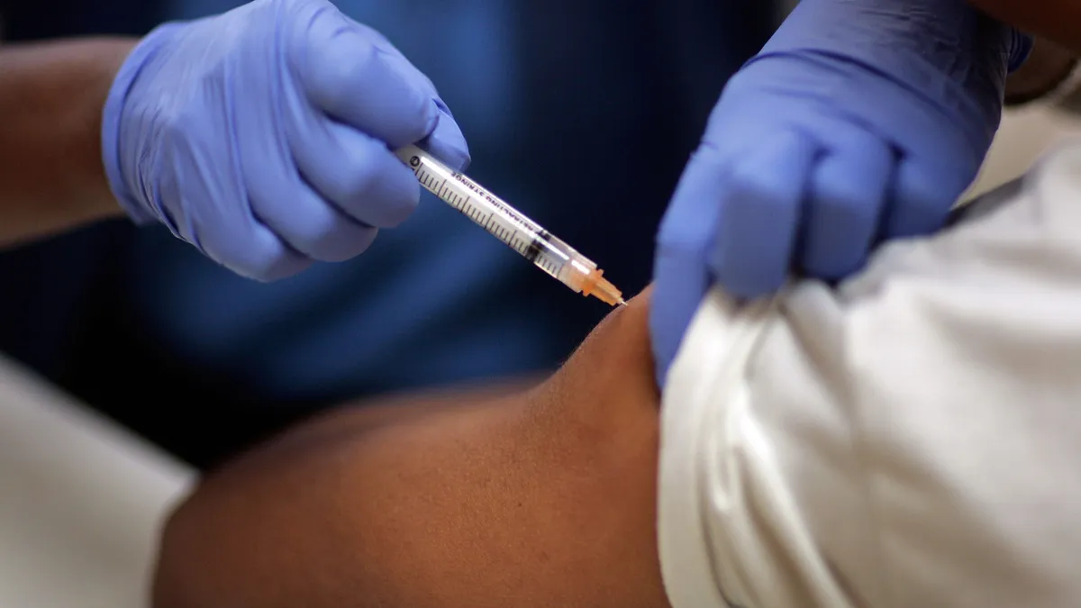 Josette Thomas, a school nurse, gives a child an immunization shot August 8, 2007 in Hialeah, Florida. The free immunization is part of the Miami-Dade County Health Department's program to help childr