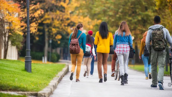 College students walk down a pathway.