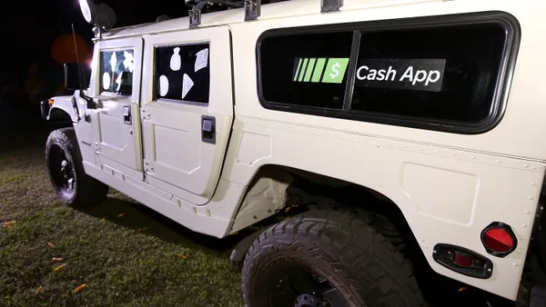 Military style vehicle with Cash App sticker on window.