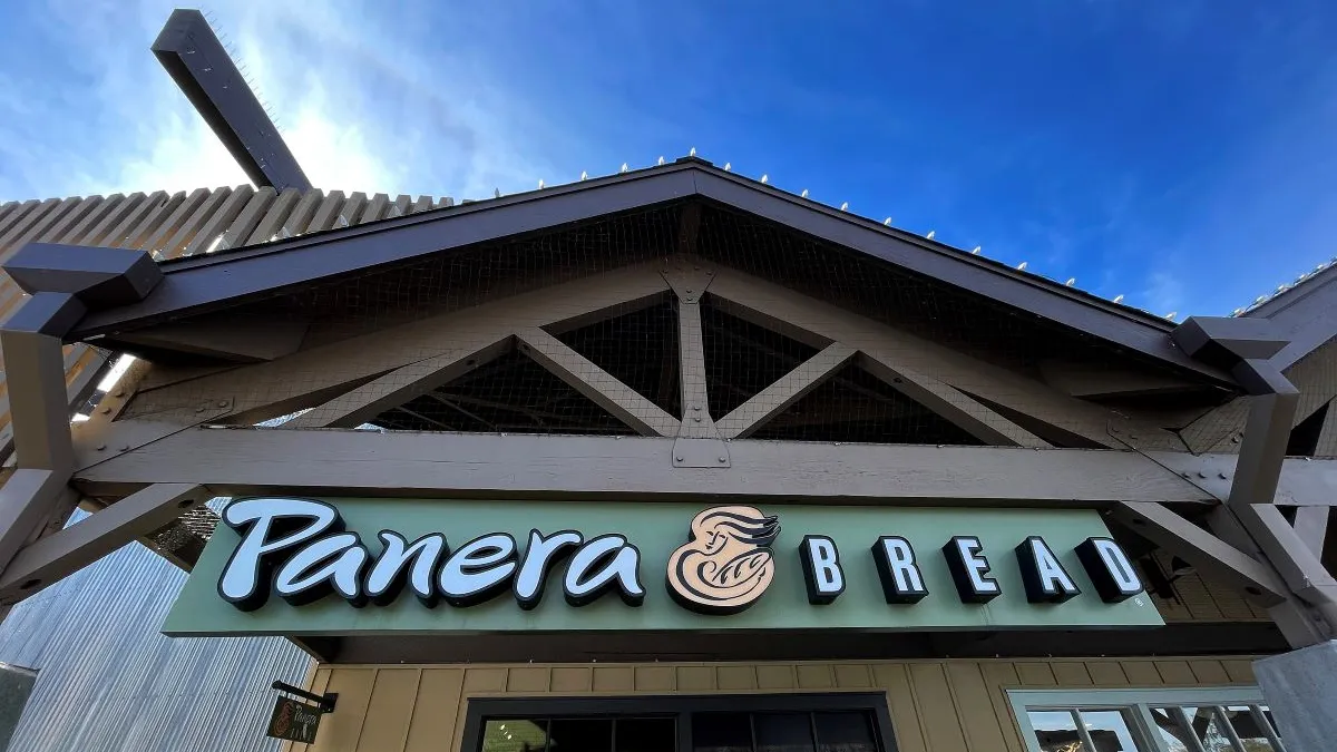 A beige building with a green sign and white lettering that says "Panera Bread."