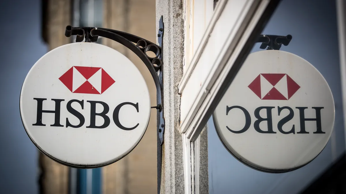 The HSBC logo is seen outside a bank branch.