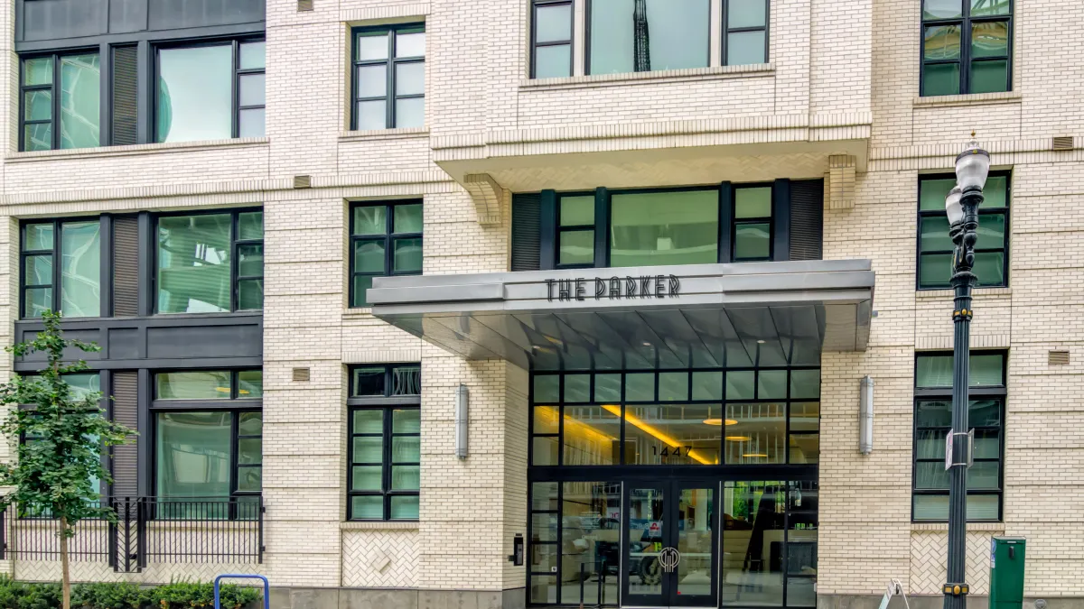 Tan, brick apartments with the words "The Parker" above the entrance.