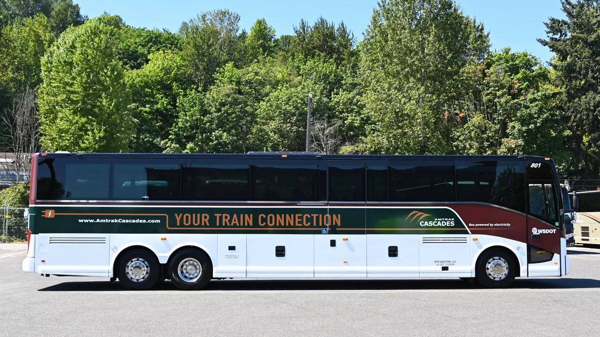 Side view of electric motor coach with Amtrak livery.