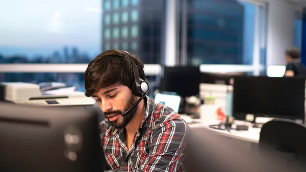 Man in an office wearing a headset