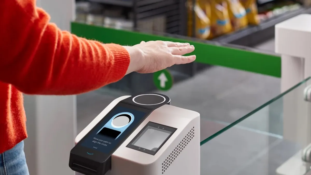 A photo of someone's hand using Amazon One palm-scanning technology to enter a store.