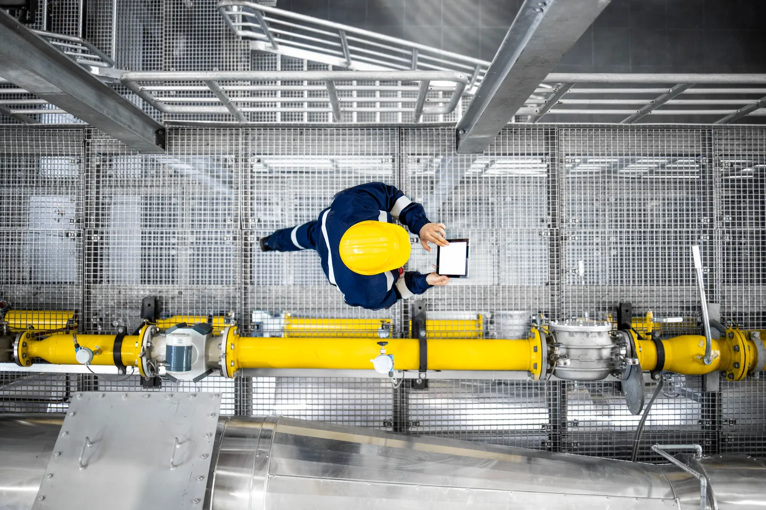 A worker walking through a factory.