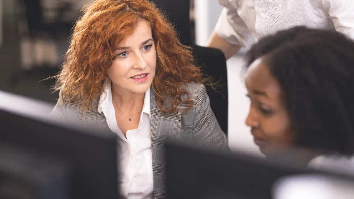 Two female employees discussing.