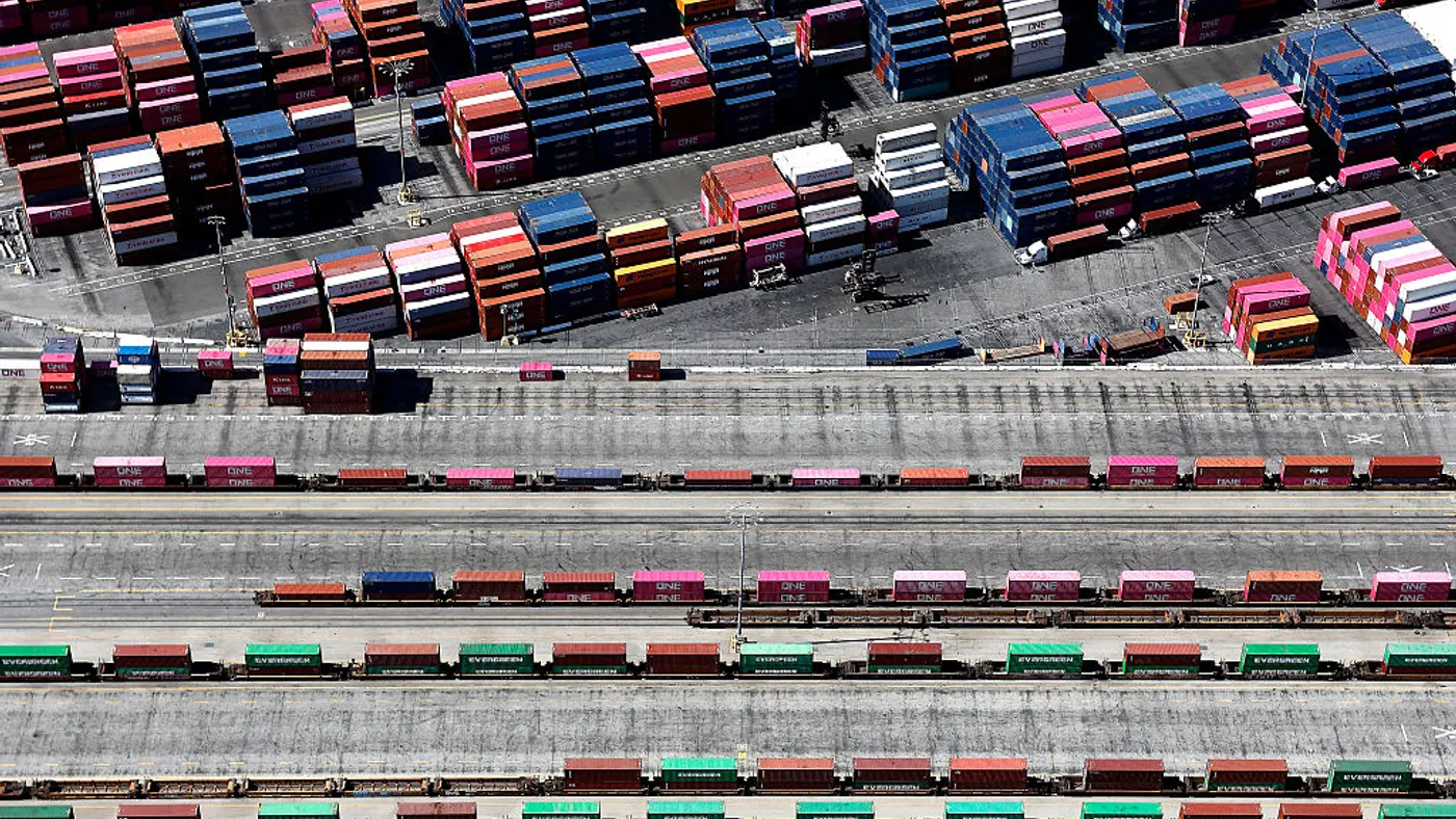An aerial view of shipping containers stacked (TOP) and on rail cars (BOTTOM) at the Port Of Los Angeles