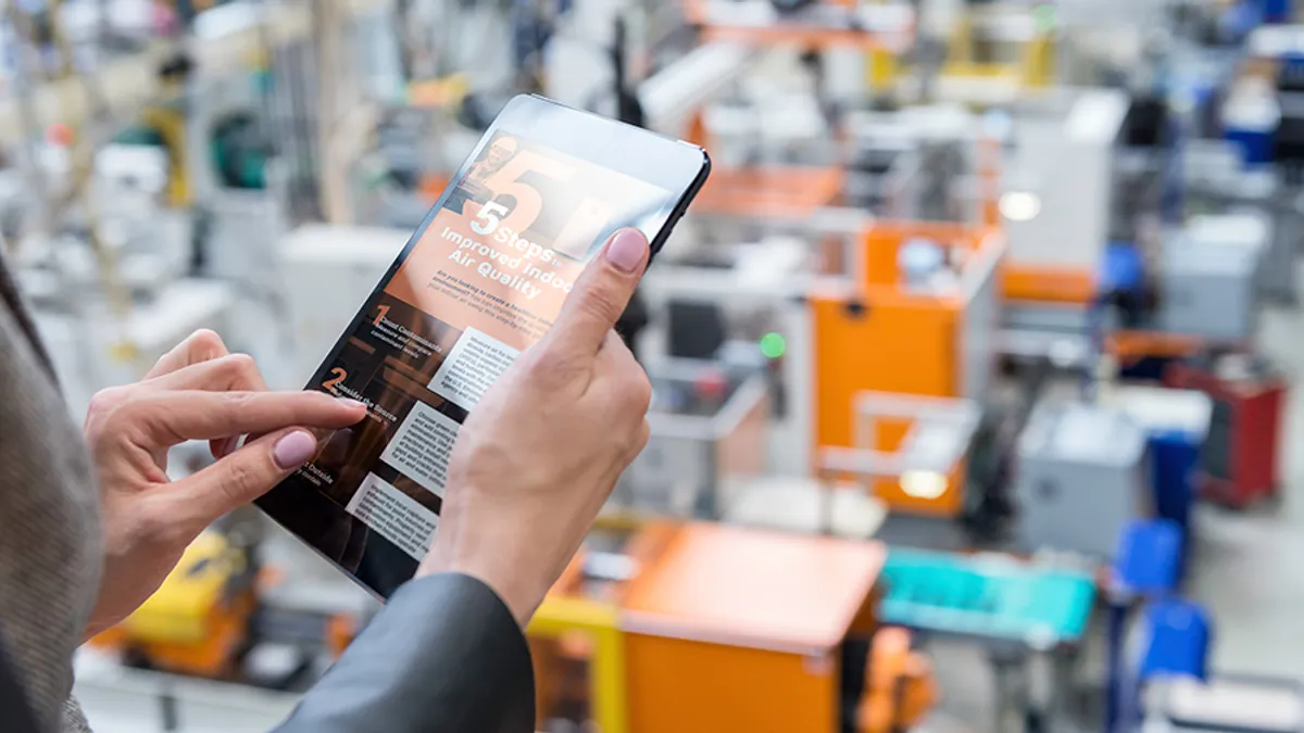 Female manager working on tablet in factory stock photo