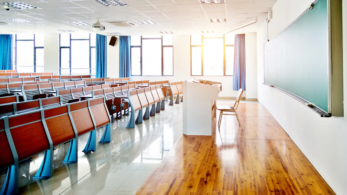 Desks and chairs in a lecture hall - stock photo