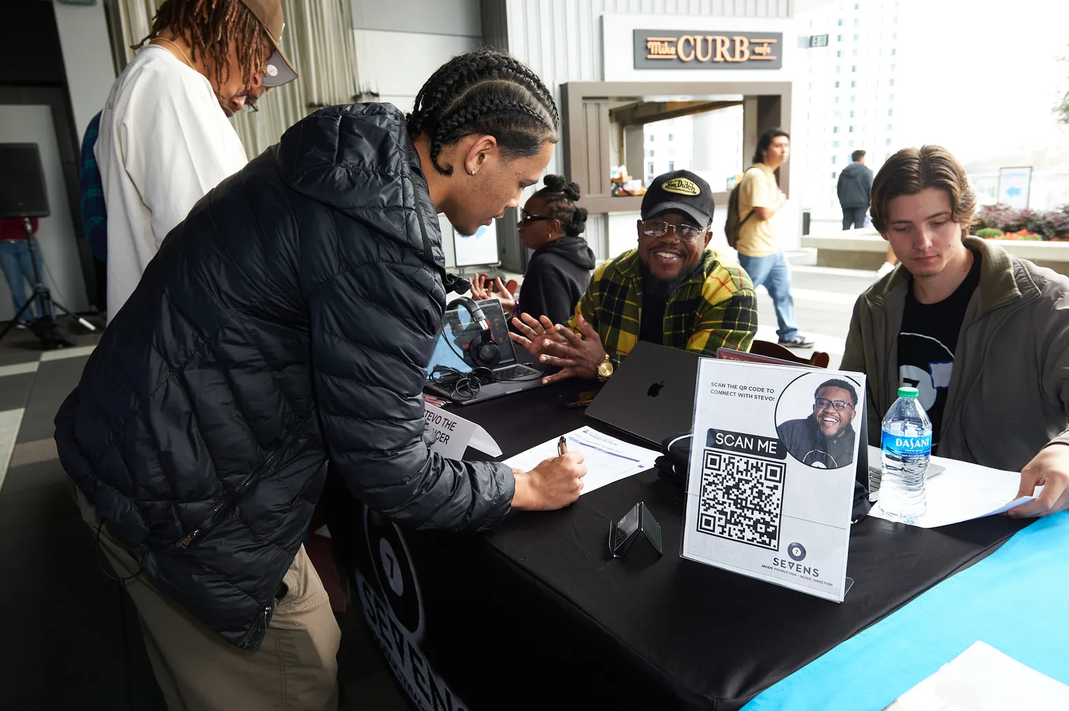 An individual visits a job fair booth.