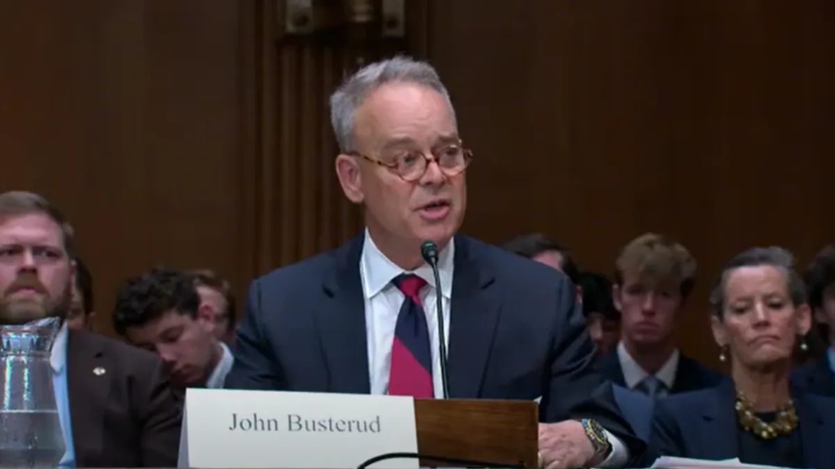 A man speaks at a podium