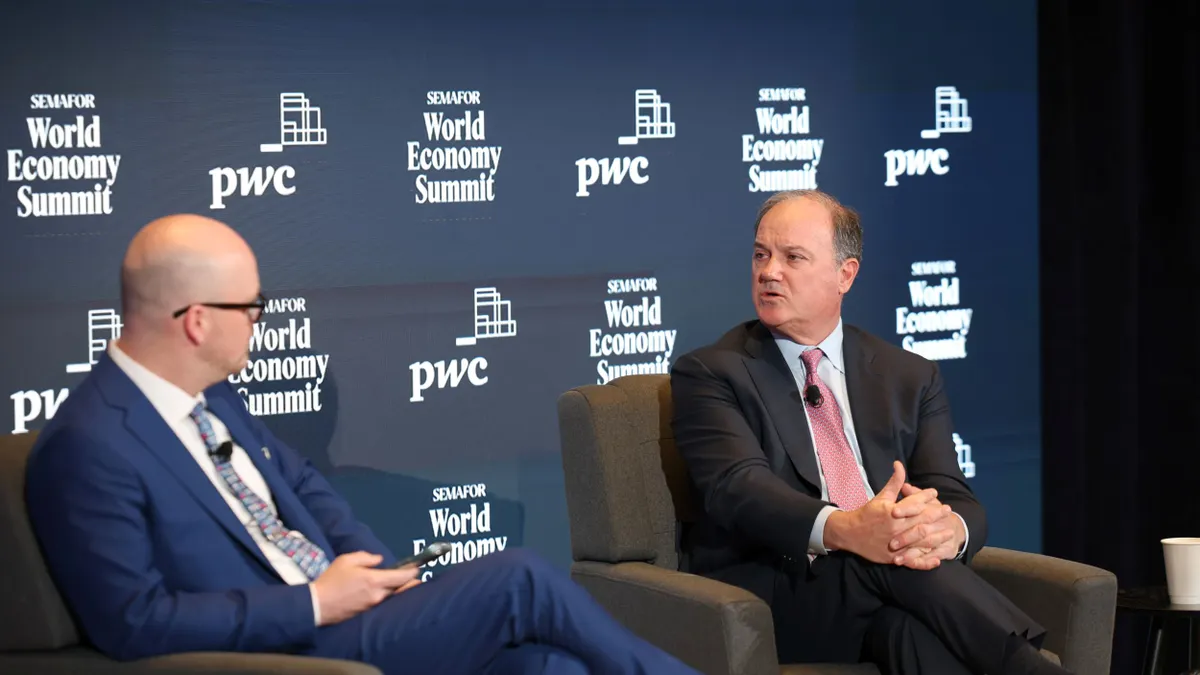 Tim McDonnell of Semafor, left, and Bob Frenzel, chairman, president and CEO of Xcel Energy, right, speak on stage