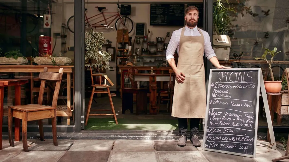 Barista standing in the doorway of a restaurant