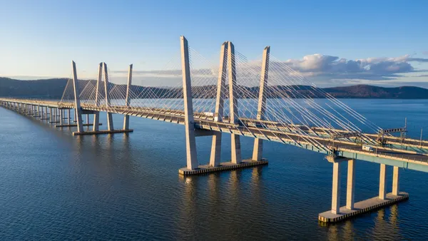 A photo during the daytime of a bridge spanning water.
