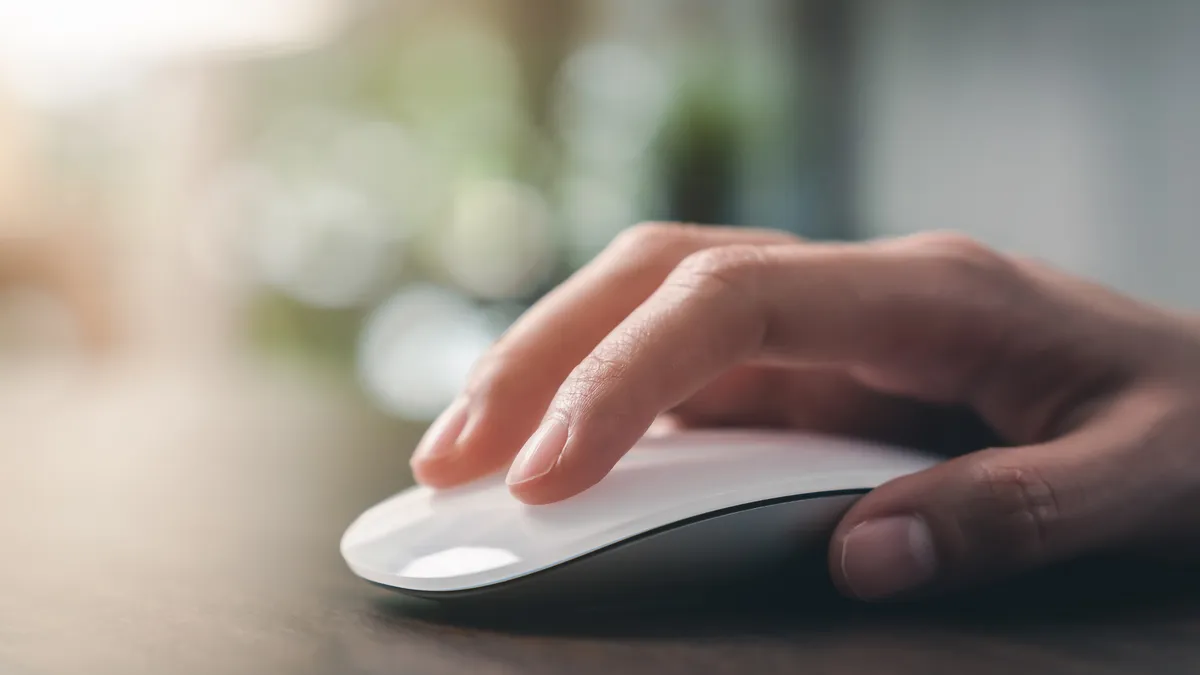 A person clicking on a computer mouse