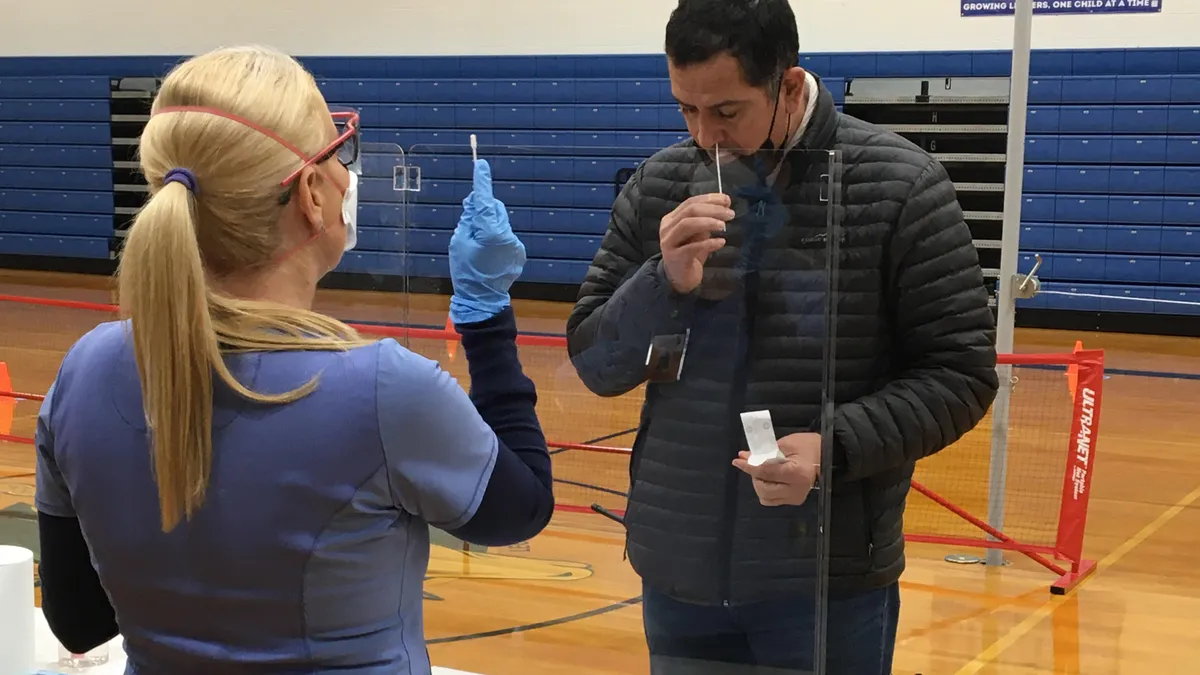 A staff member from McSwain Union Elementary School District in Merced, California participates in the district's voluntary COVID-19 testing pilot.