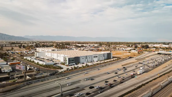 An EV company's new assembly plant next to a highly trafficked highway.