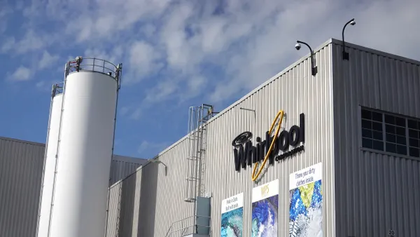 Exterior view of a manufacturing facility with the Whirlpool Corporation logo on the side