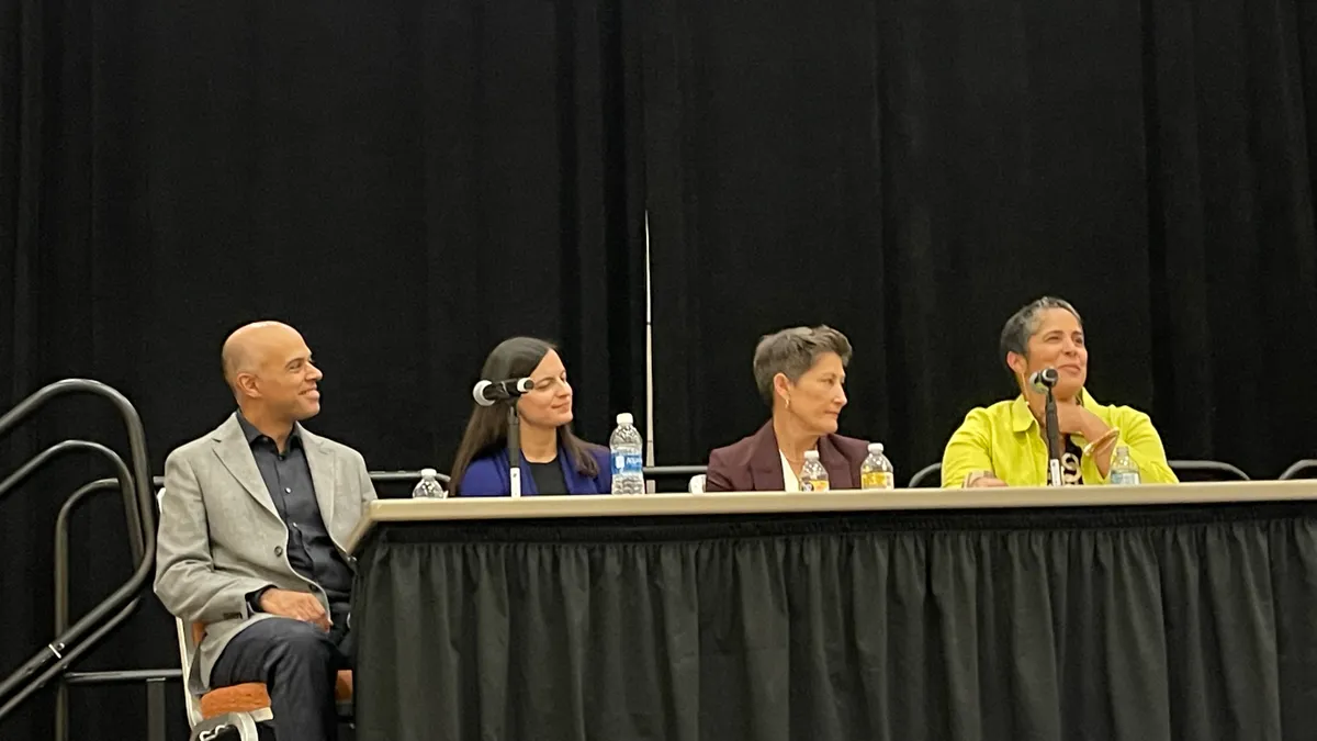 Several people sit on a panel for NACAC.