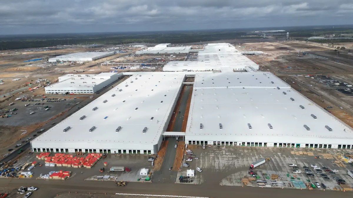 A white building surrounded by construction.