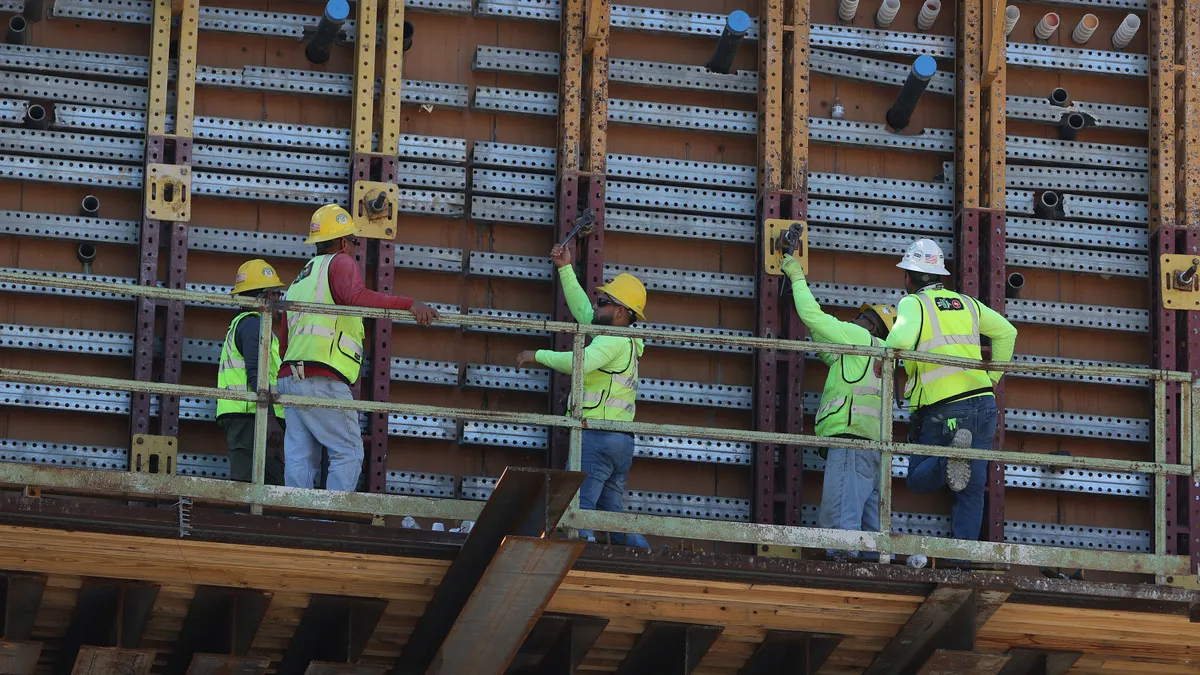 Construction workers work on an infrastructure project.