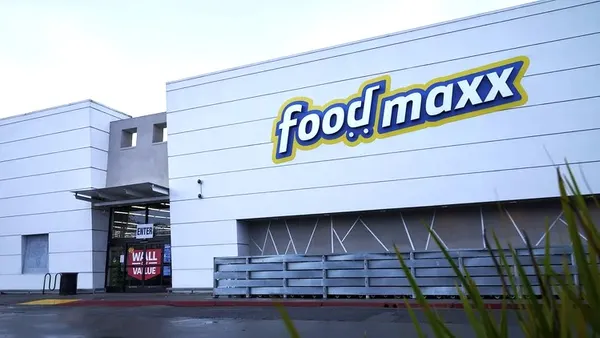 Exterior of a light gray building with a sign that reads "FoodMaxx."
