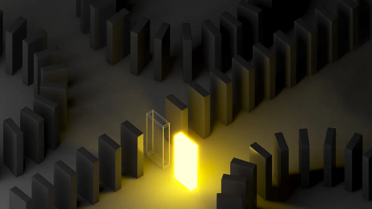 a brilliantly lit domino piece stands out amid several rows of black dominos