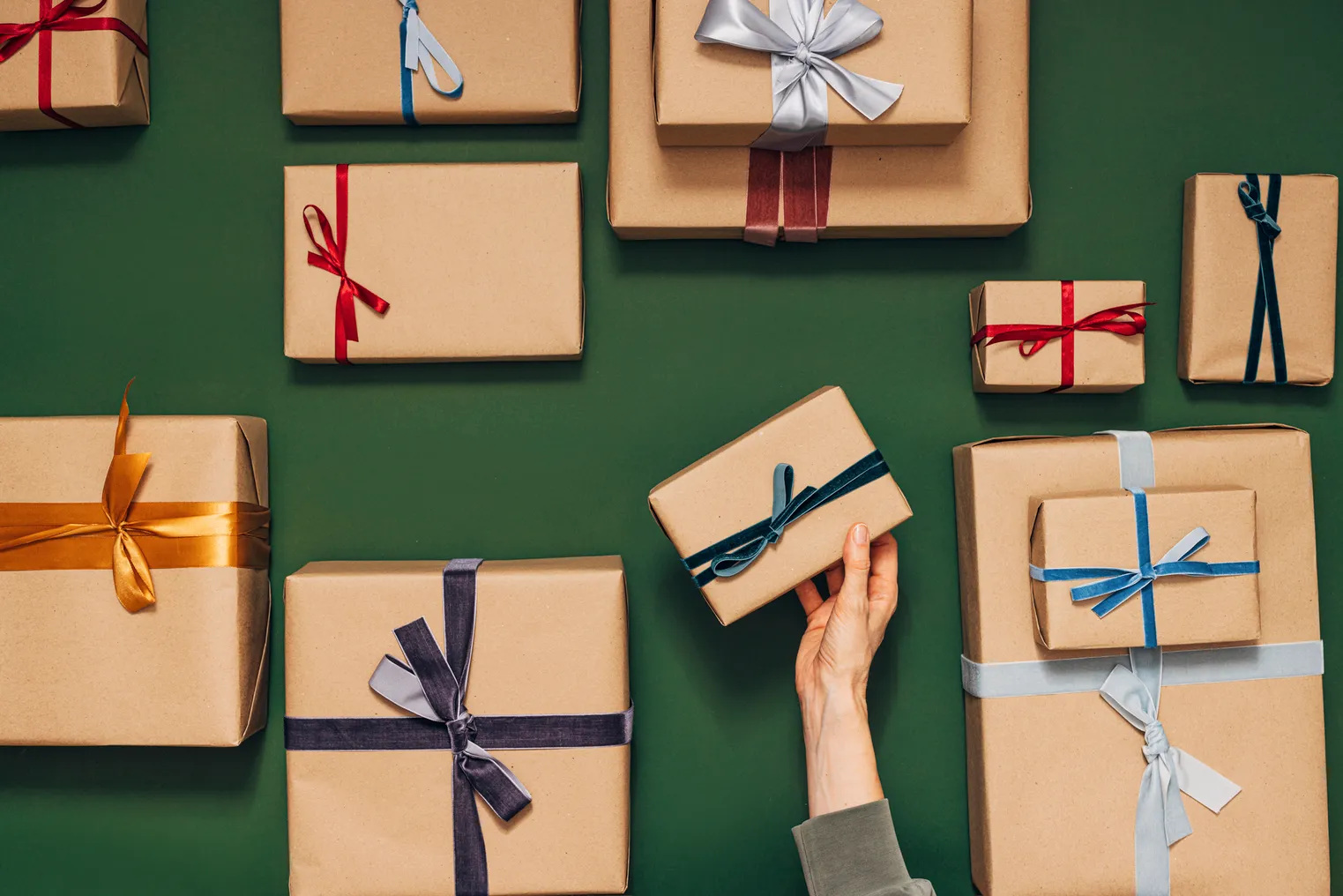 Many wrapped presents on a green background